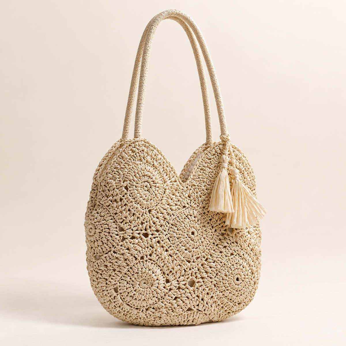 Hollow Weave Tassel Bag, angled view showing rosette crochet motifs and a side tassel