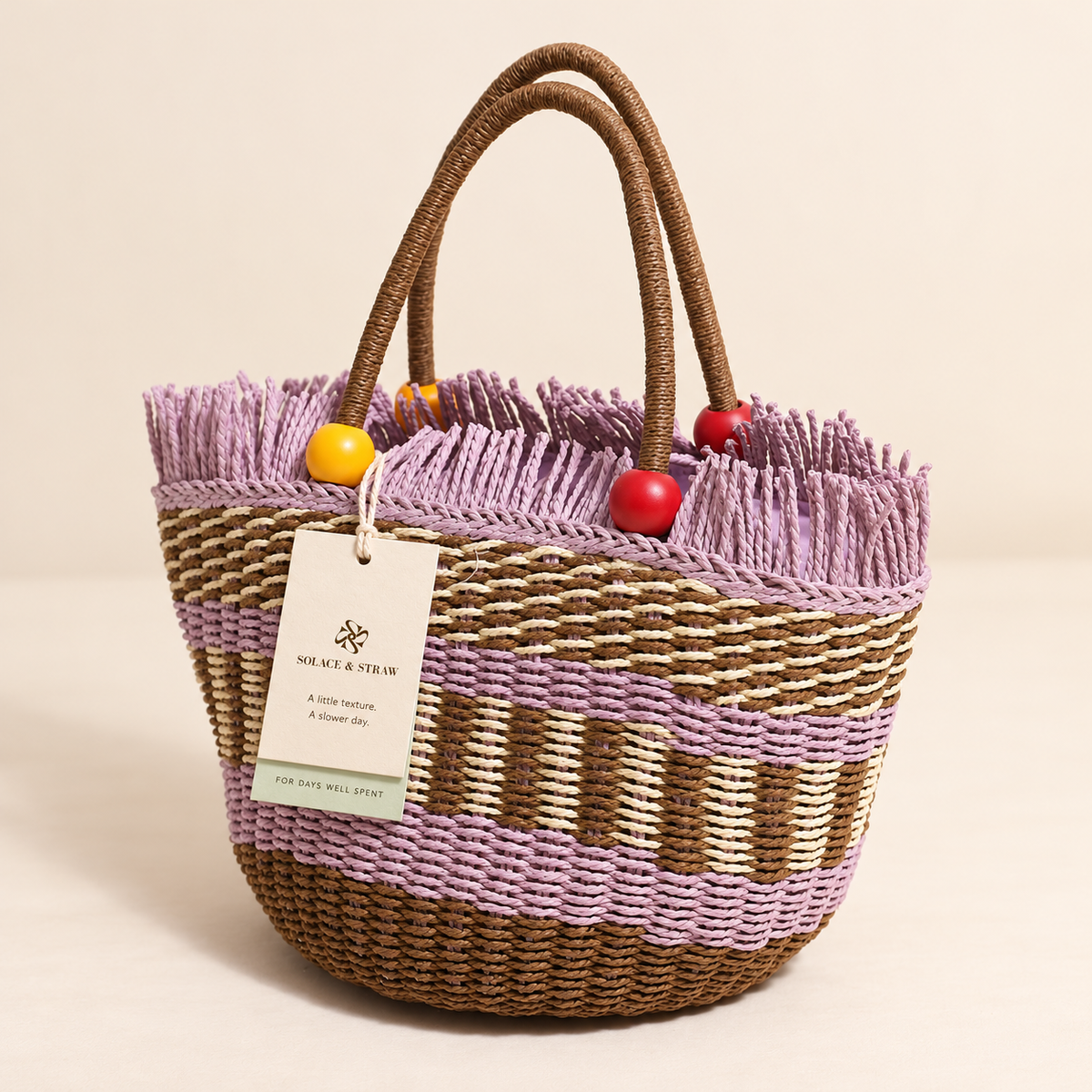 Wooden Bead Bucket Bag with purple woven accents and beaded handles, front view with a Solace & Straw hangtag