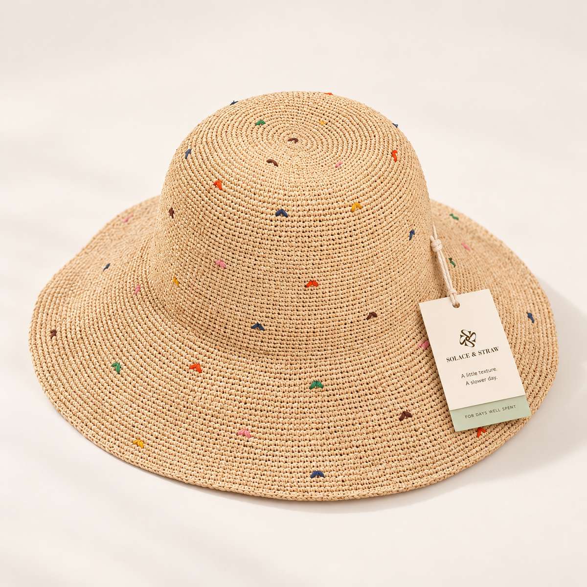 Color Dot Sun Hat in natural straw with a Solace & Straw hangtag