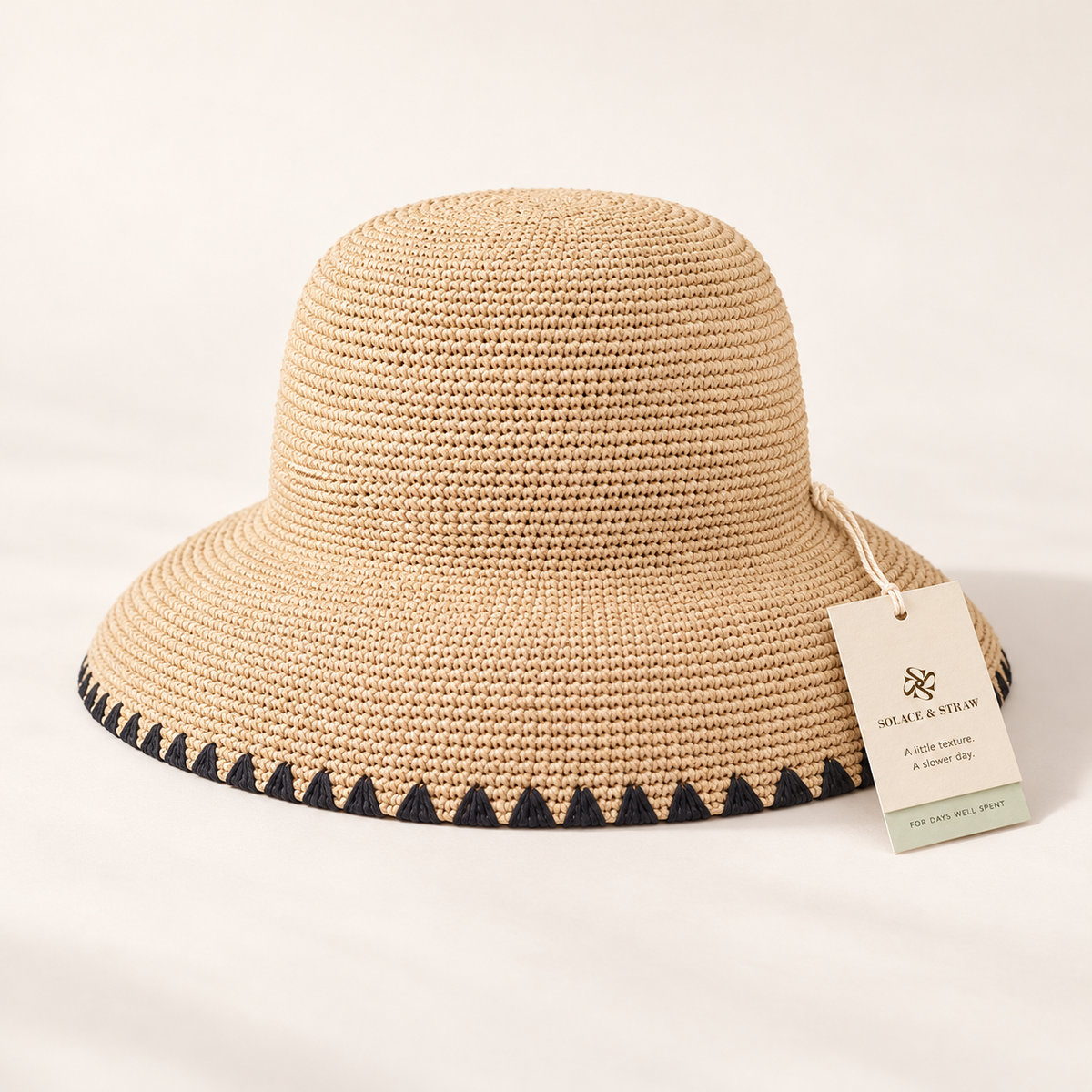 Black Trim Straw Hat in natural straw with a Solace & Straw hangtag