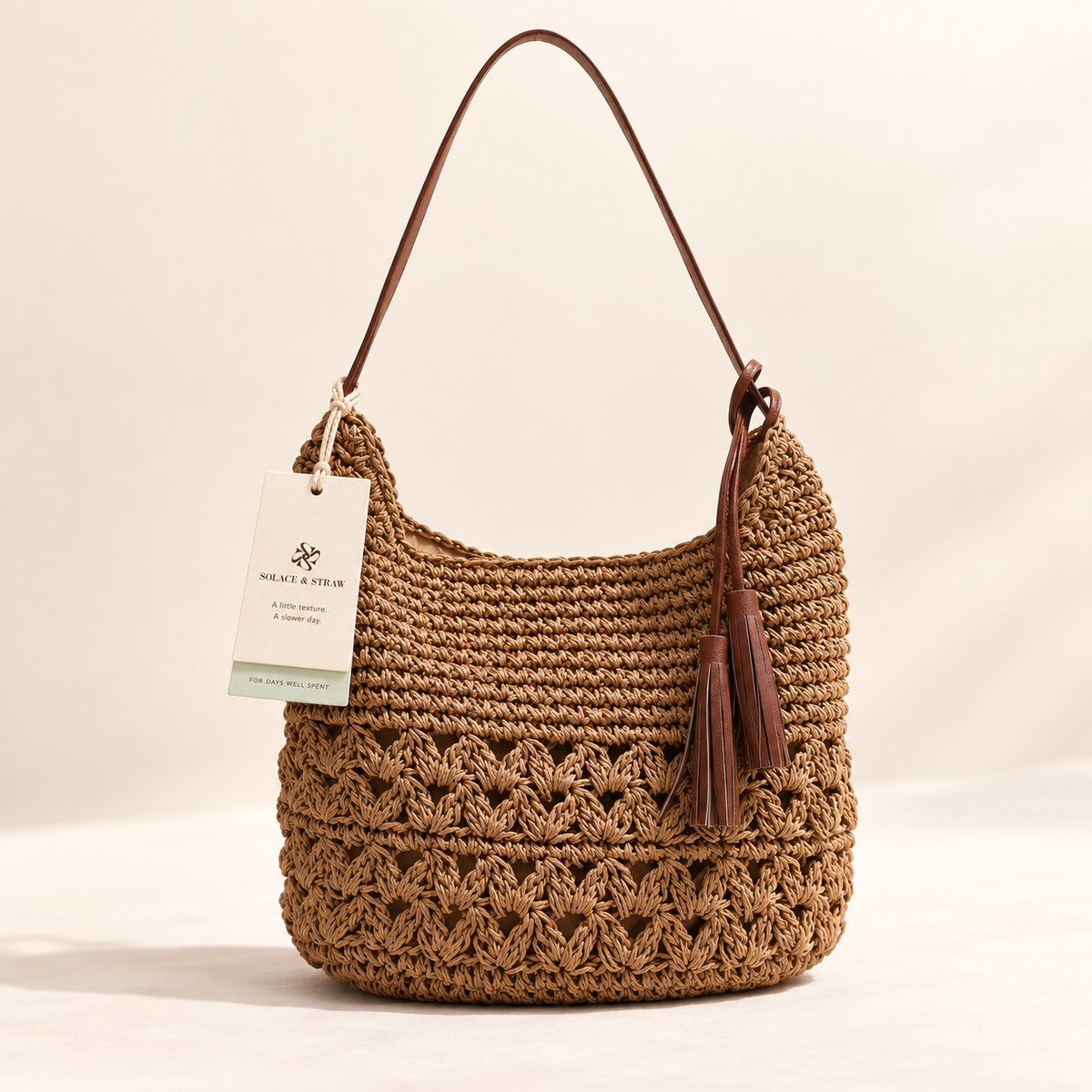 Heart Tassel Shoulder Bag in brown with a Solace & Straw hangtag