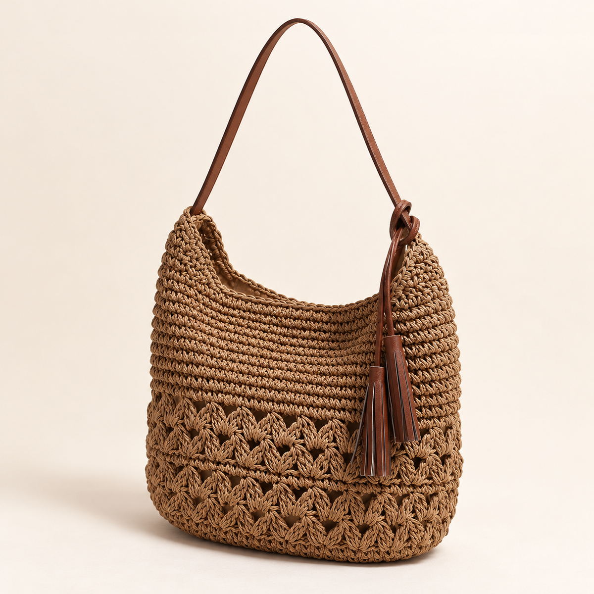 Heart Tassel Shoulder Bag, angled view showing heart-pattern openwork and a side tassel