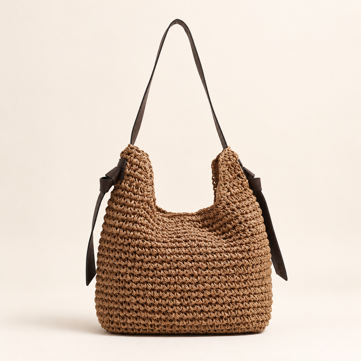 Tassel Cylinder Bag in brown, front view with a dark shoulder strap and long side ties