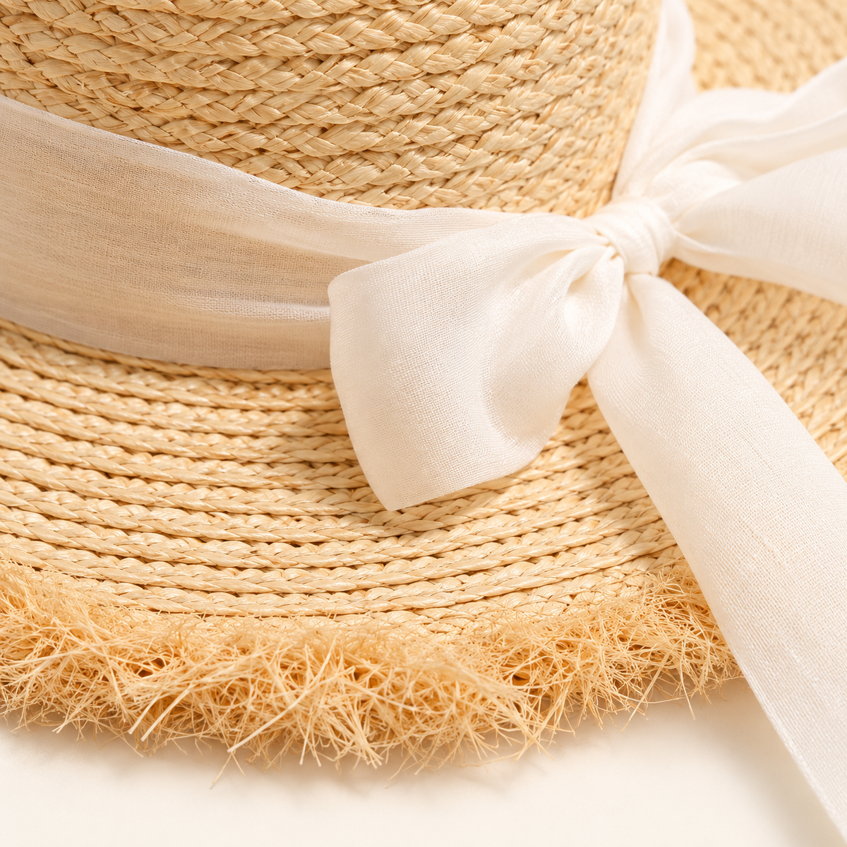 Ribbon Straw Sun Hat, close-up of the straw weave and frayed brim edge