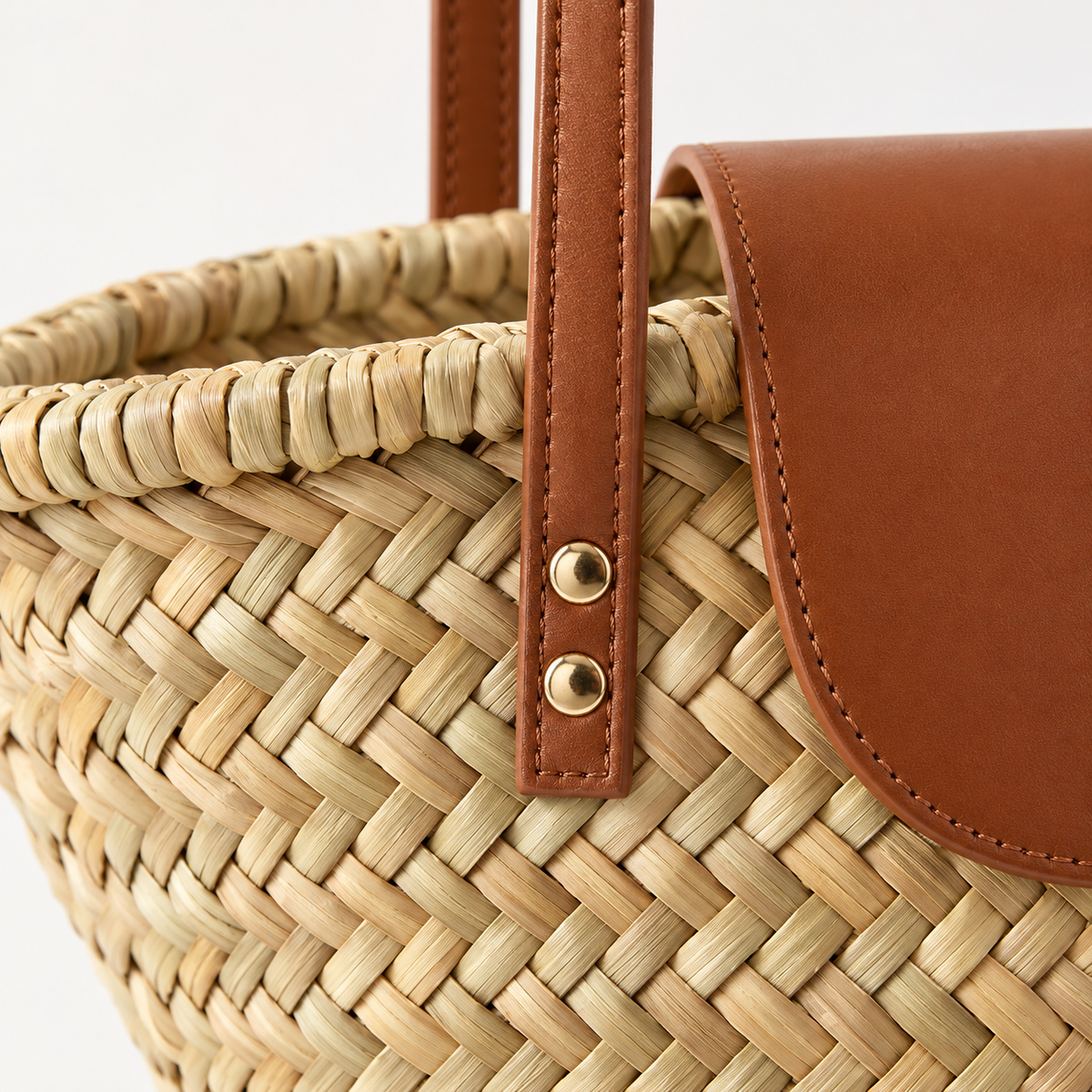 Shell Shape Shoulder Bag, close-up of the herringbone weave and riveted handle attachment