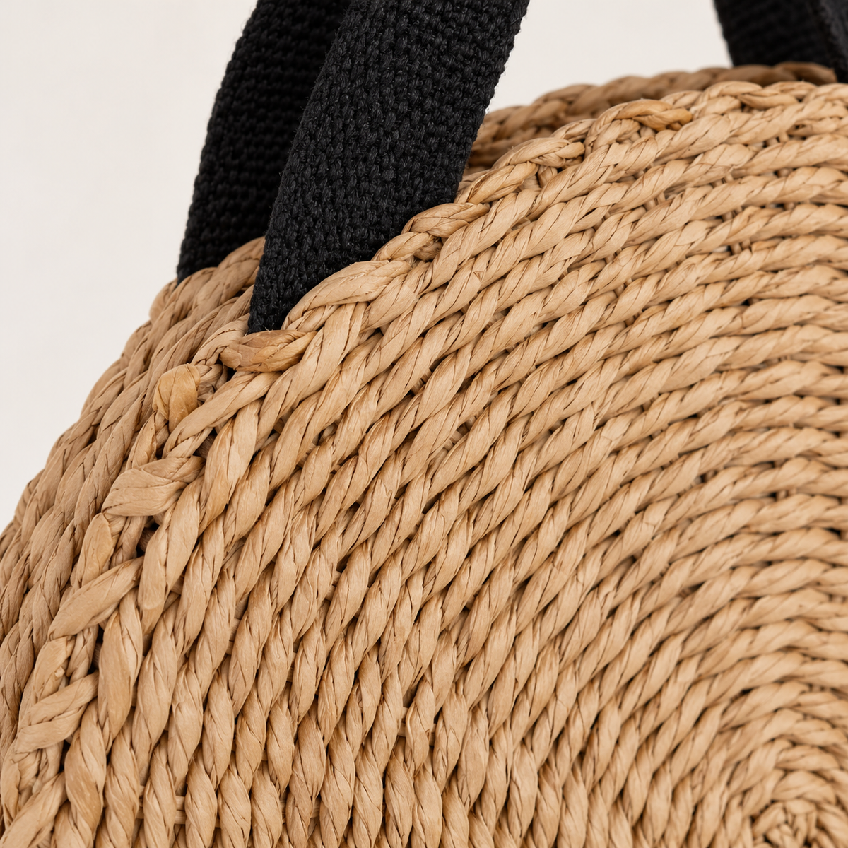Round Woven Crossbody, close-up of the coiled woven texture and strap clip