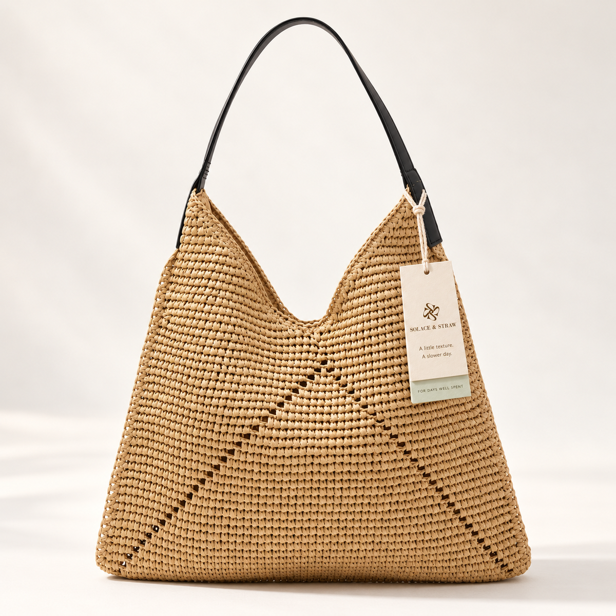 Triangle Stitch Paper Woven Hobo in light brown / black strap, front view with Solace & Straw hangtag