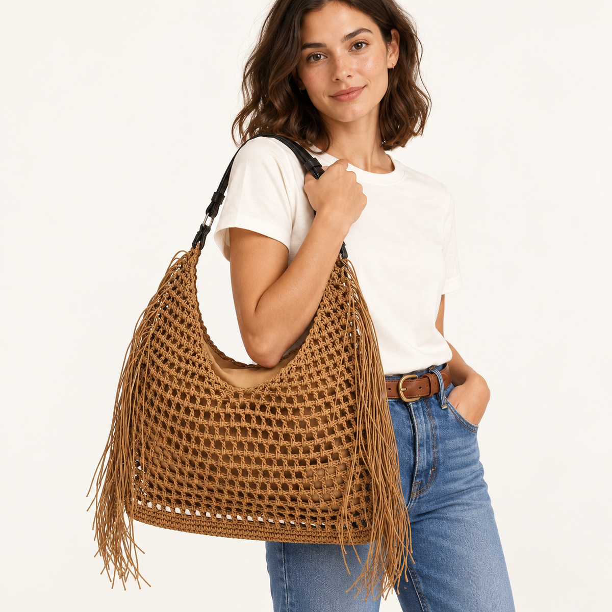 Woman carrying the Tassel Woven Tote with open crochet and side fringe