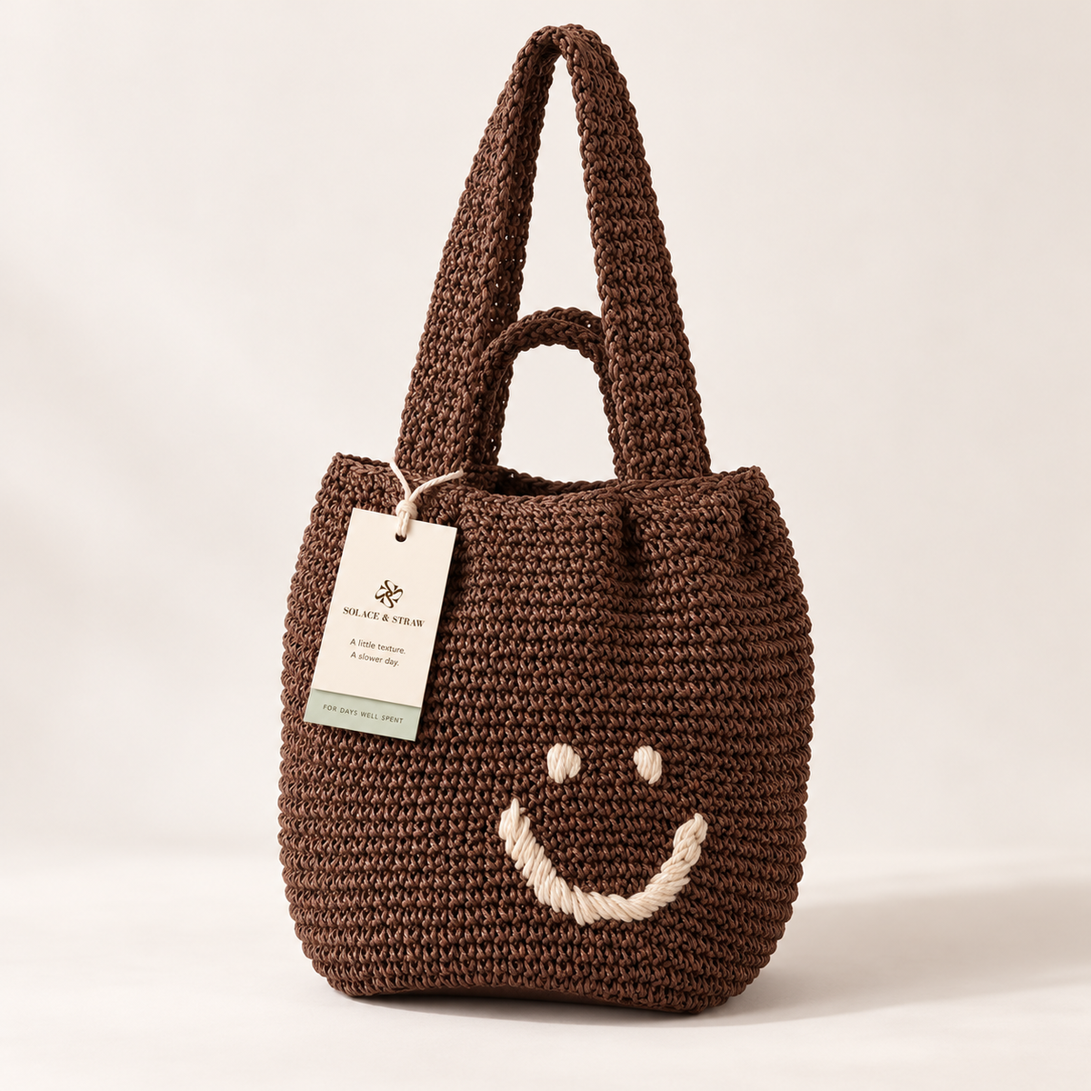 Smiley Woven Shoulder Bag in brown with a Solace & Straw hangtag