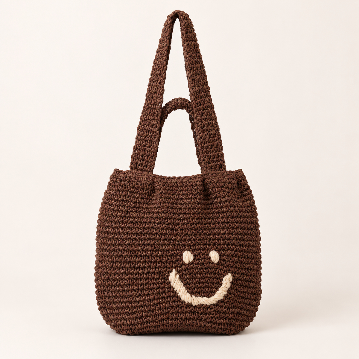 Smiley Woven Shoulder Bag in brown, front view with a stitched smiley face