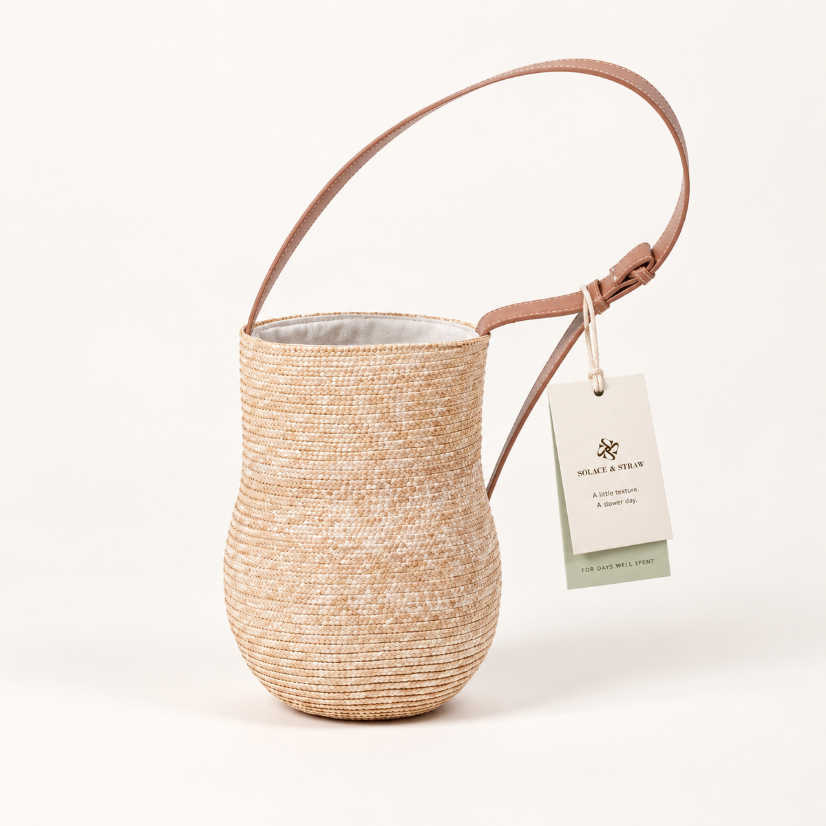 Gourd Shape Shoulder Bag in natural straw with a Solace & Straw hangtag