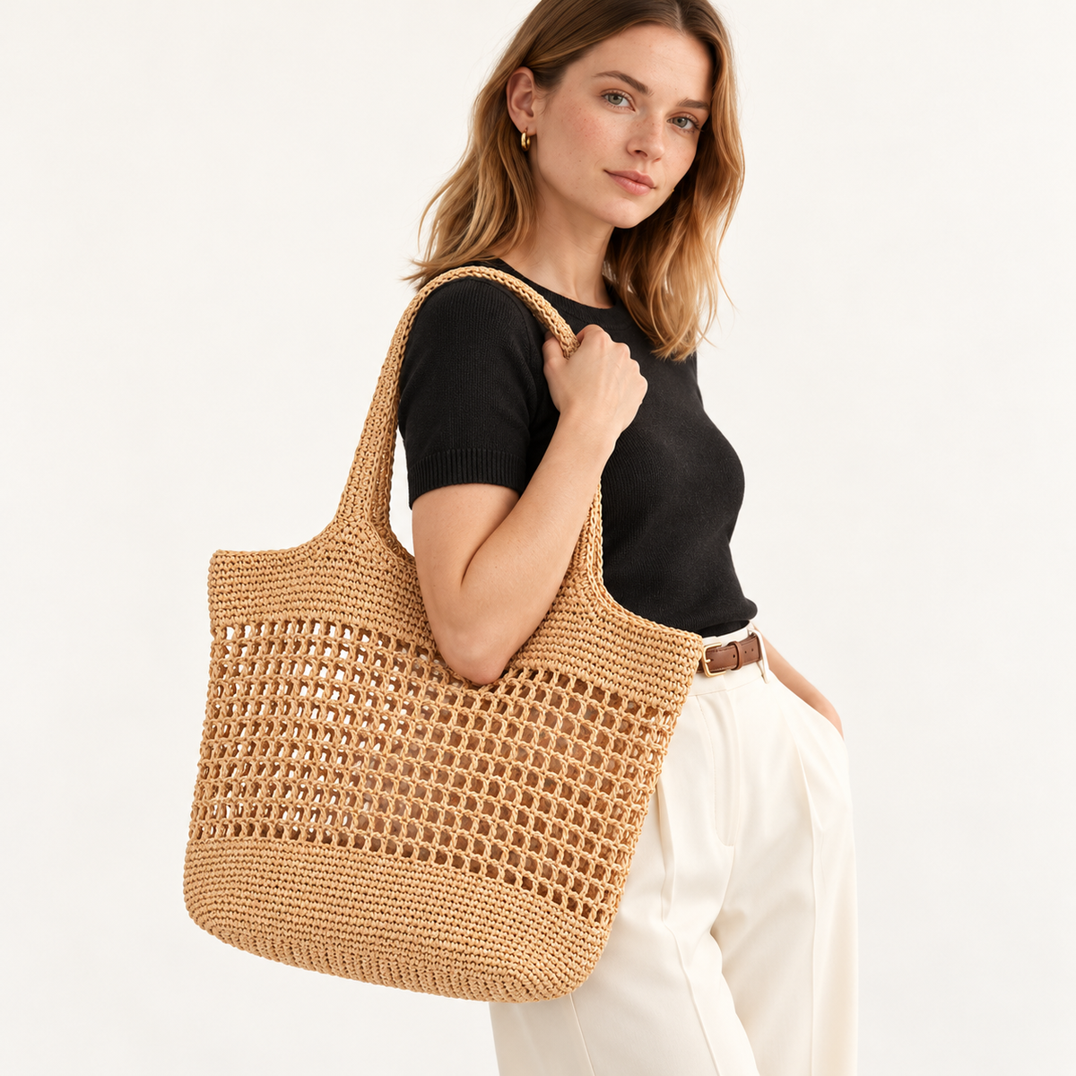 Woman carrying the Open Weave Tote with a rectangular open mesh body