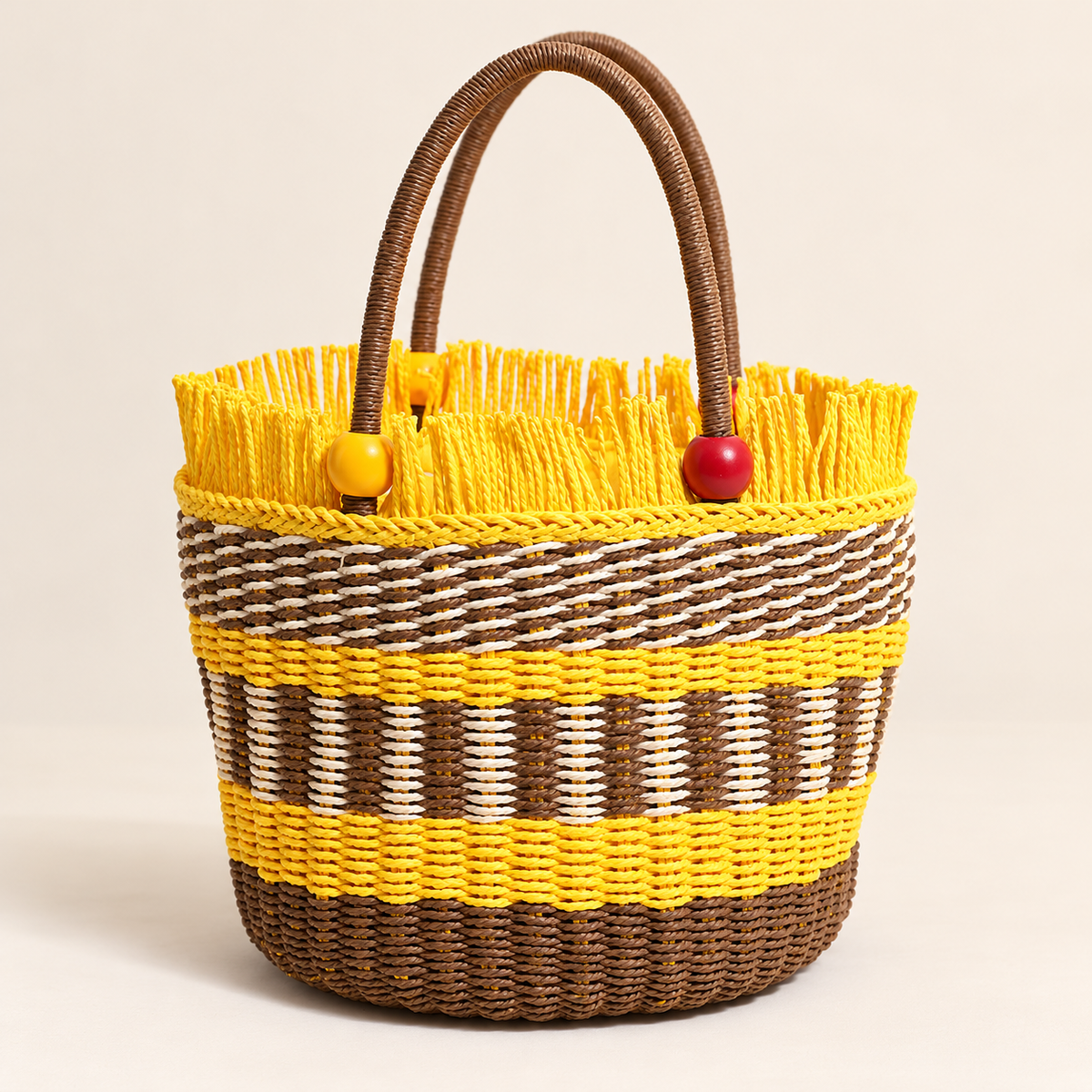 Wooden Bead Bucket Bag in tan with yellow accents, front view with beaded handles and a fringed rim