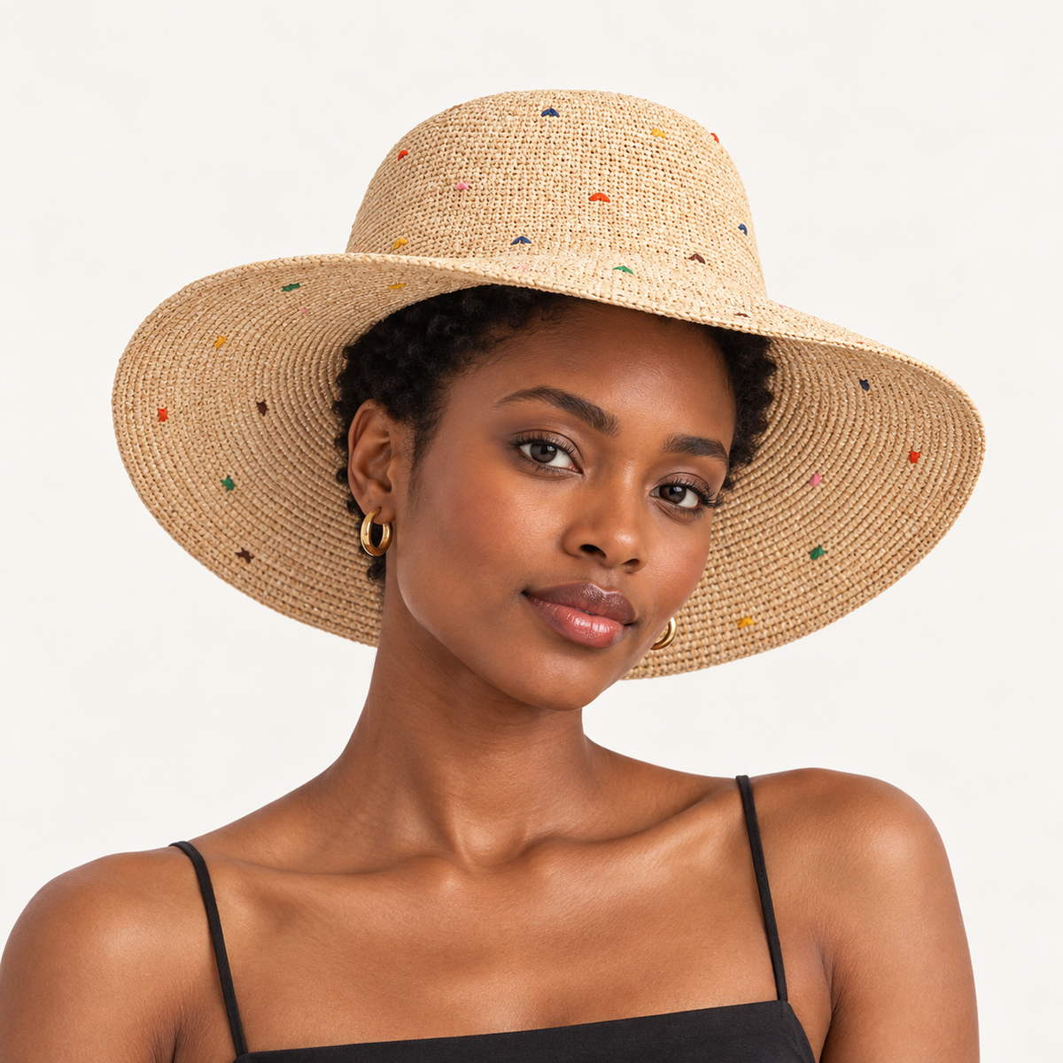 Woman wearing the Color Dot Sun Hat with a wavy brim and small multicoloured dots