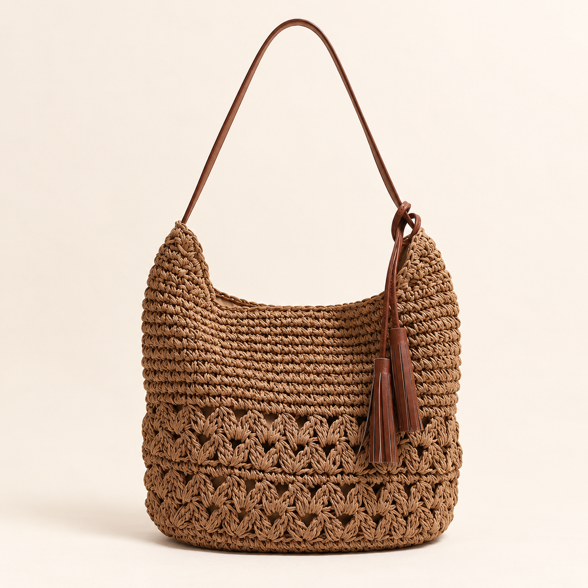 Heart Tassel Shoulder Bag in brown, front view with heart-pattern openwork and a side tassel
