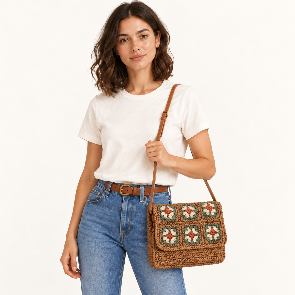 Woman carrying the Floral Woven Crossbody with floral crochet squares on the flap