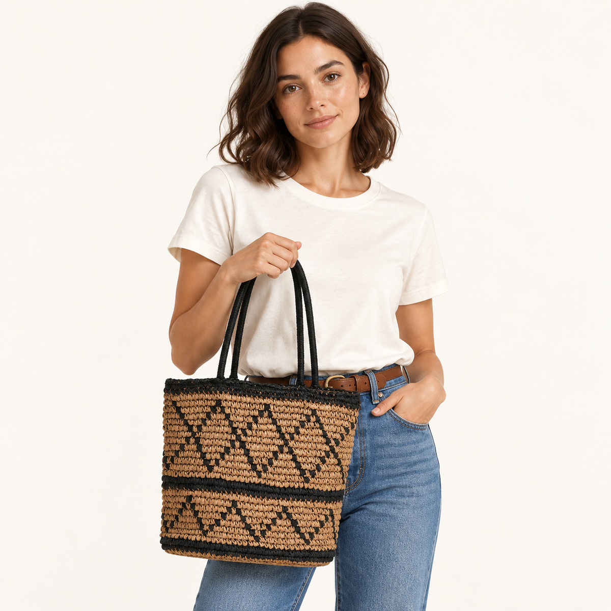 Woman carrying the Diamond Weave Shoulder Bag with a diamond pattern and black handles