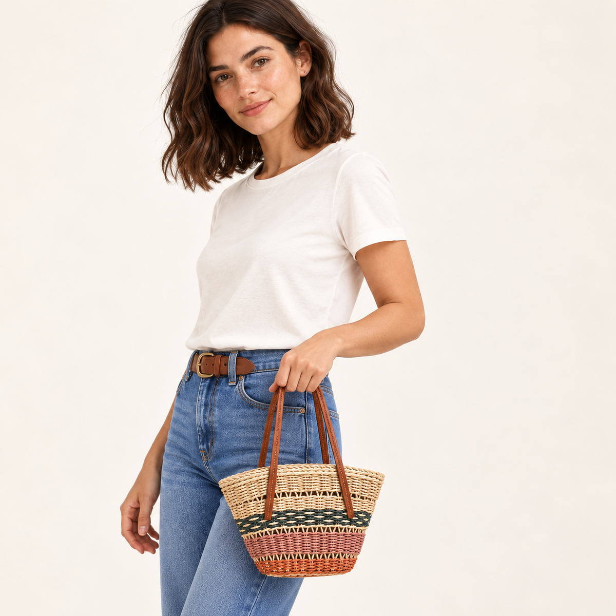 Woman carrying the Color Block Basket Tote with green, pink and orange woven bands