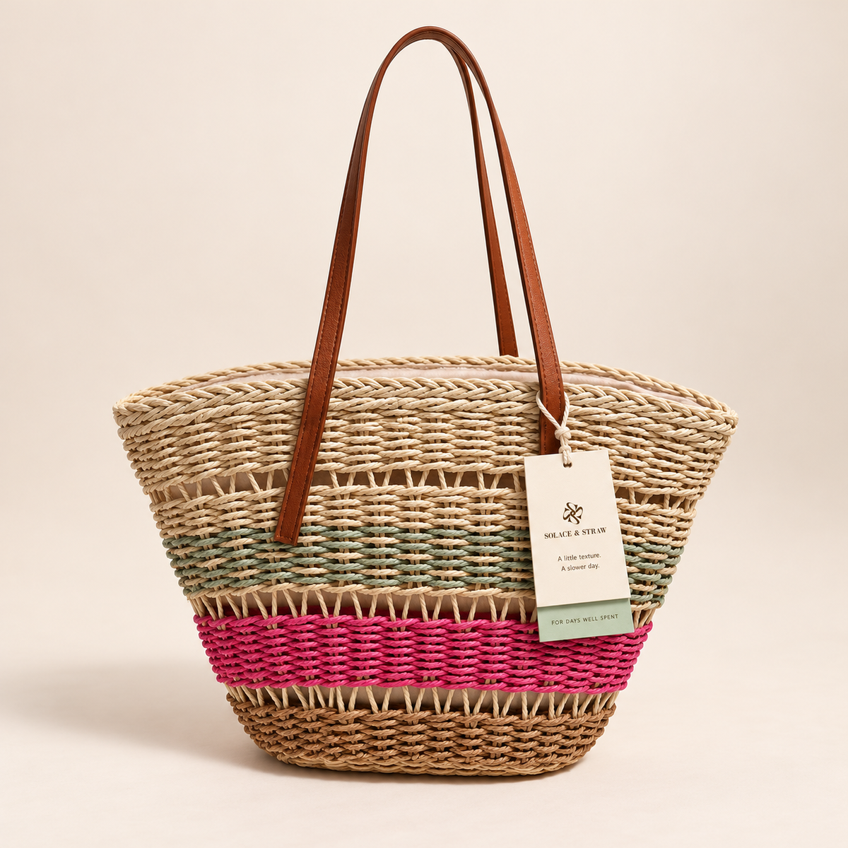 Color Block Basket Tote with green, pink and coffee-brown woven bands, front view with a Solace & Straw hangtag