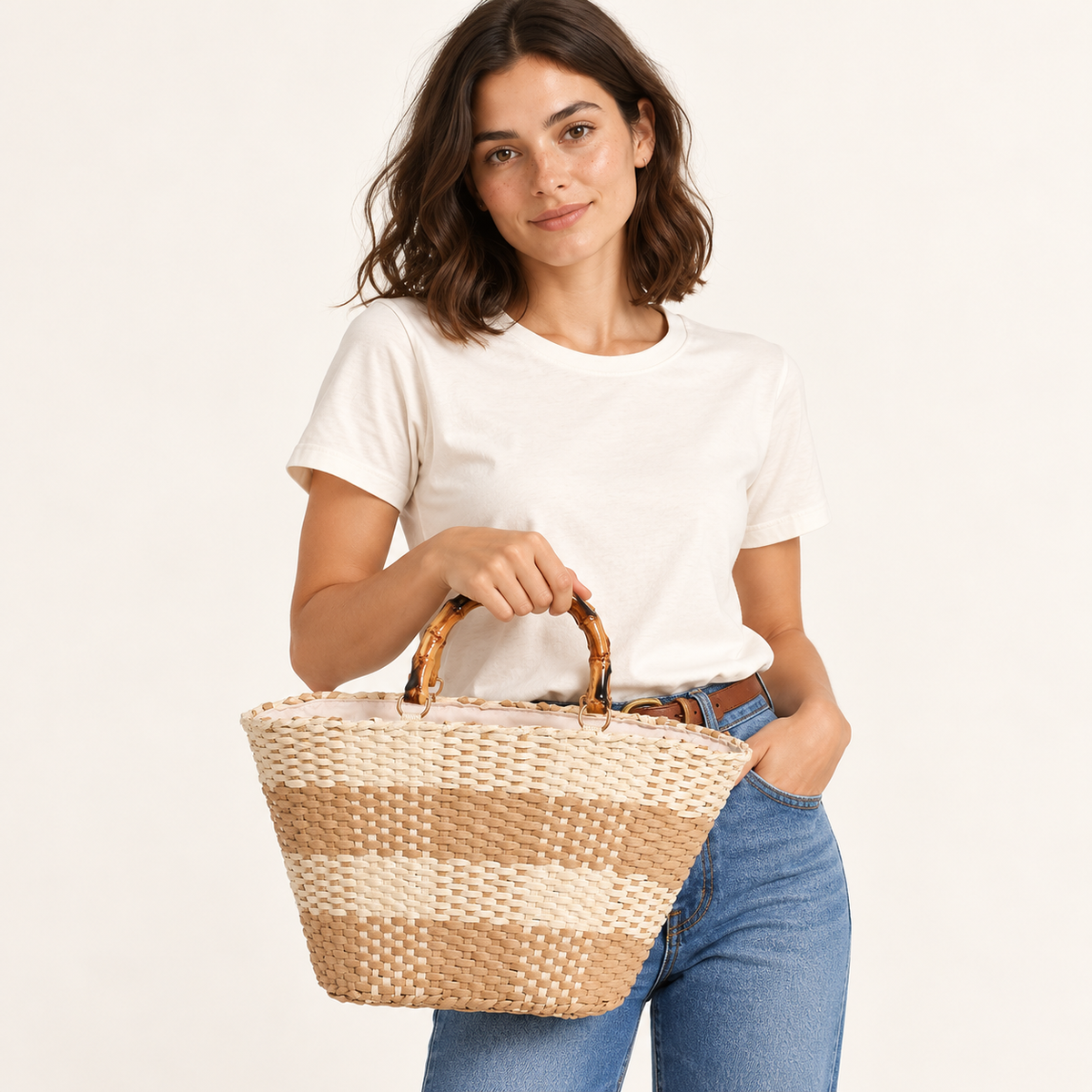 Woman carrying the Grid Woven Tote with curved bamboo-style handles