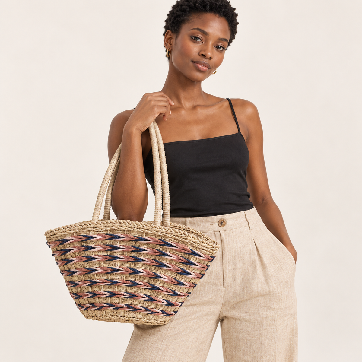 Woman carrying the Forest Woven Shoulder Bag with pink and navy rope bands