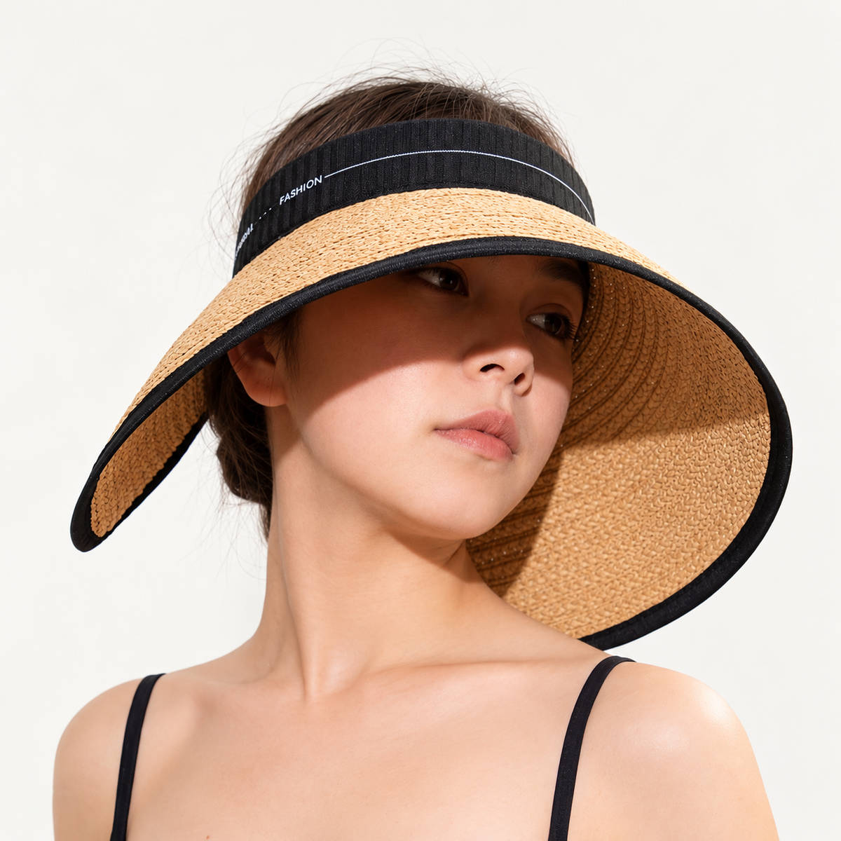 Woman wearing the Wide Brim Straw Visor with an open top and black FASHION band