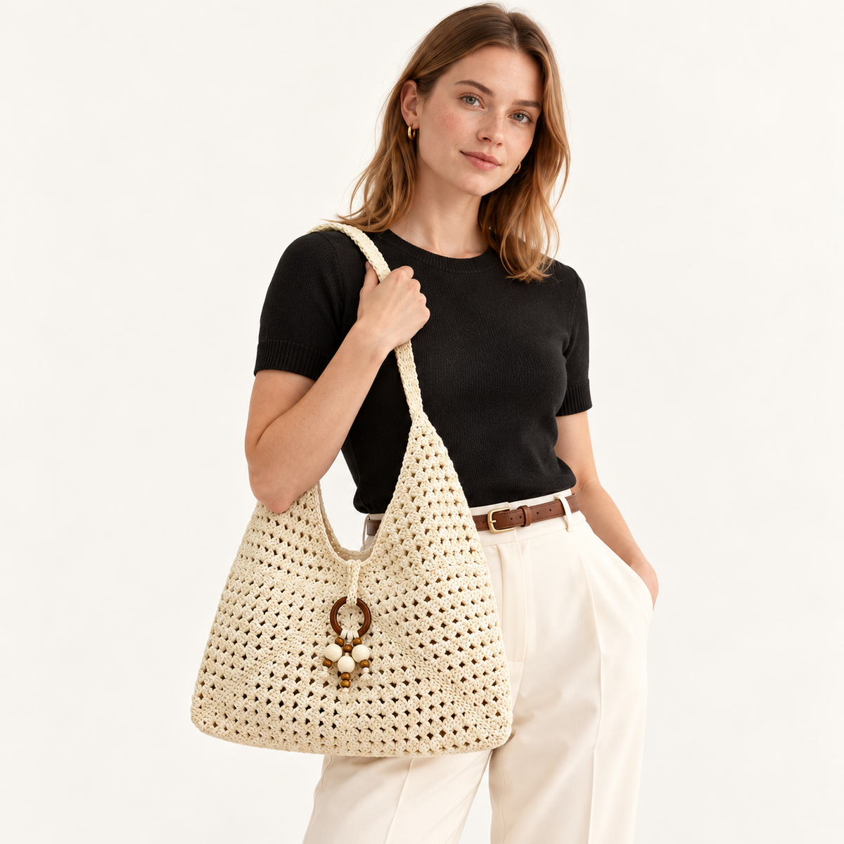 Woman carrying the Granny Square Cotton Shoulder Bag in ivory, studio styling