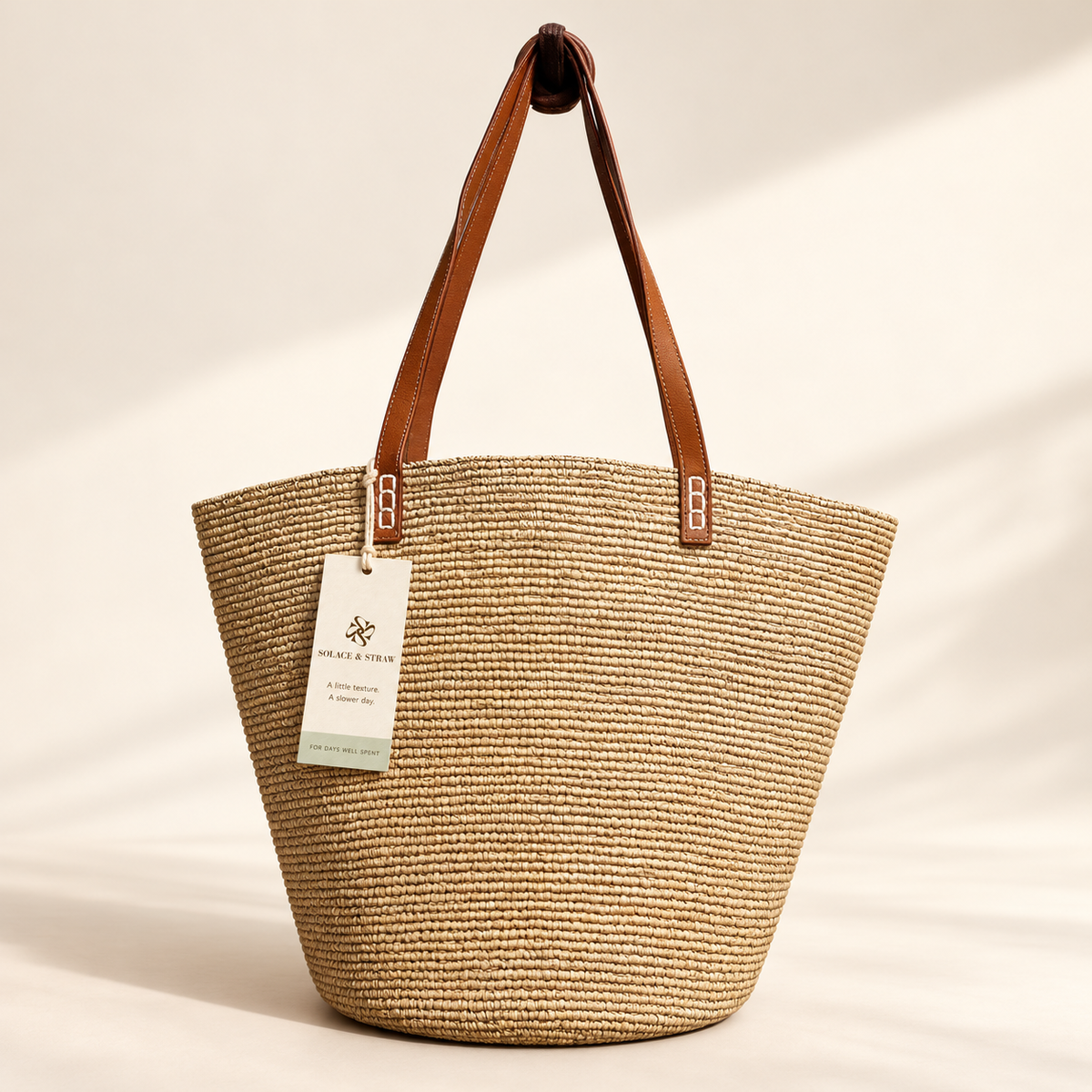 Raffia Bucket Shoulder Tote in natural, front view with Solace & Straw hangtag