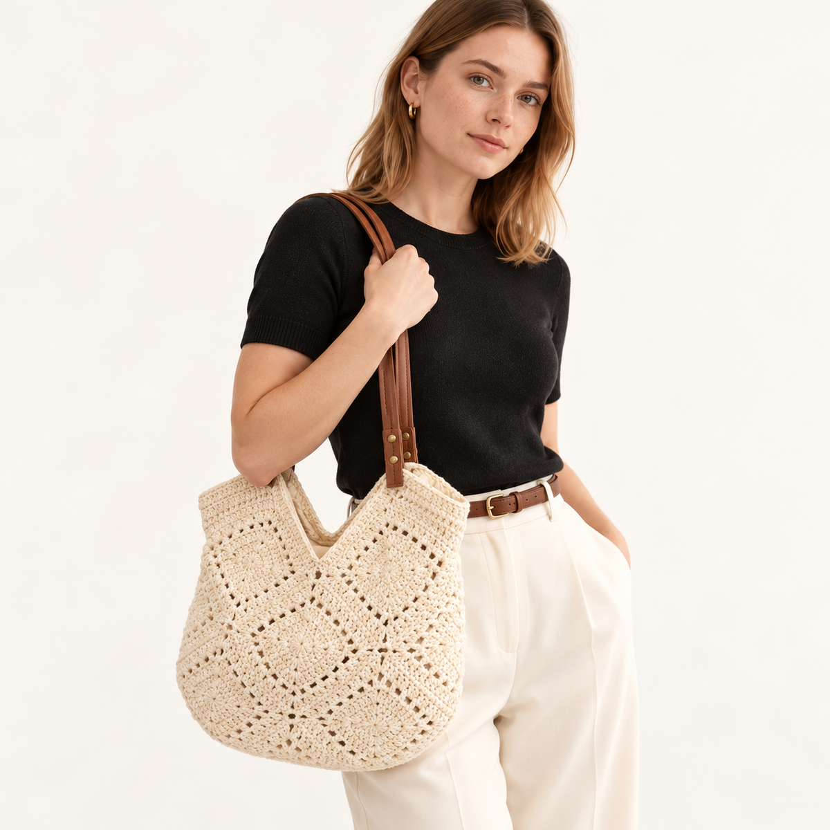 Woman carrying the Crochet Patchwork Shoulder Bag in ivory / no charm, studio styling