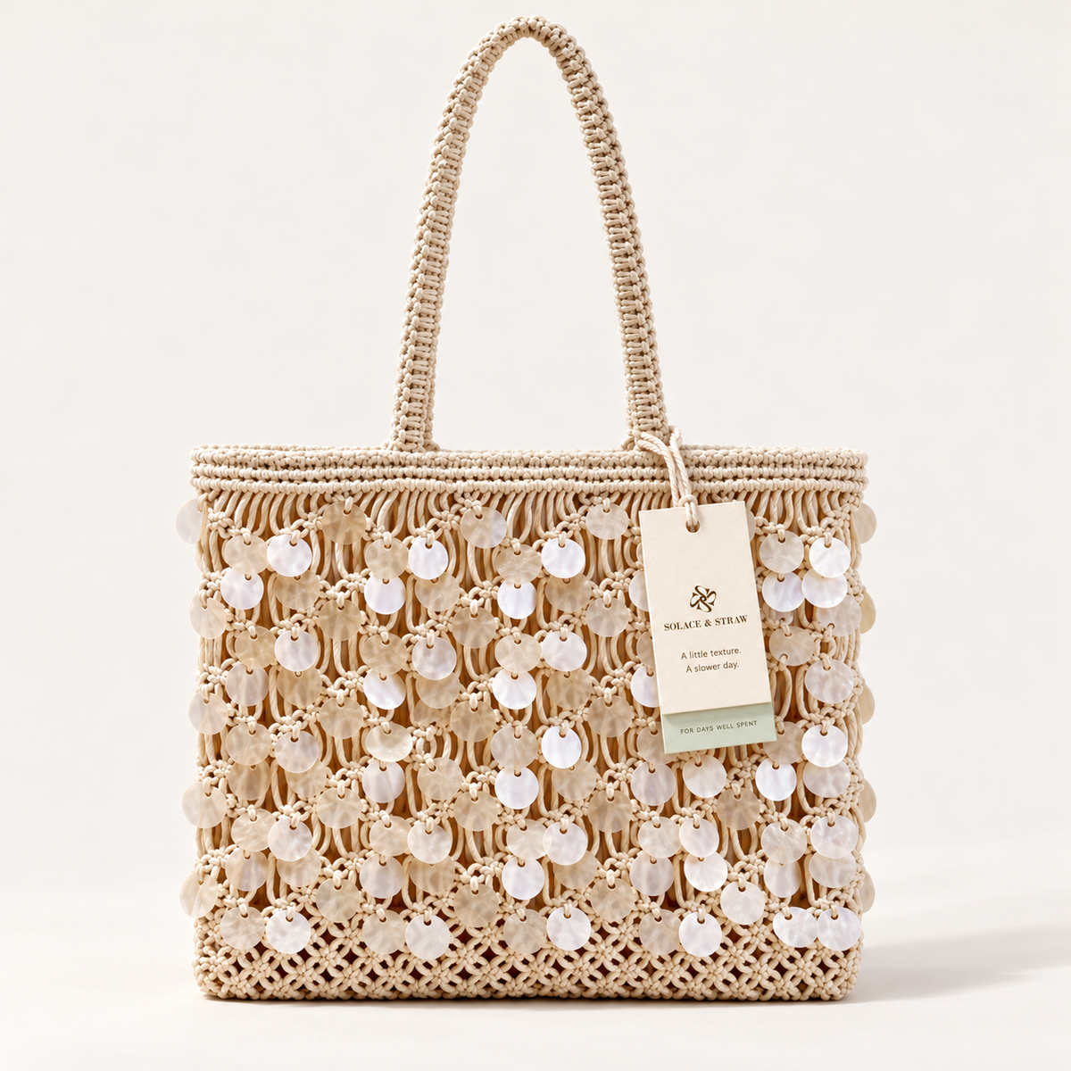 Shell Detail Cotton Net Tote in ivory, front view with Solace & Straw hangtag