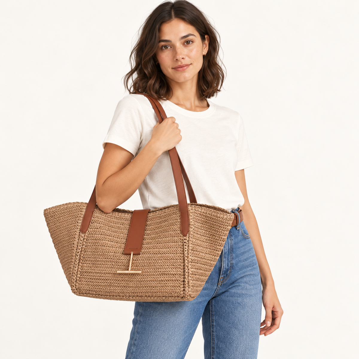 Woman carrying the Bar Detail Woven Basket Tote in tan / brown trim, studio styling