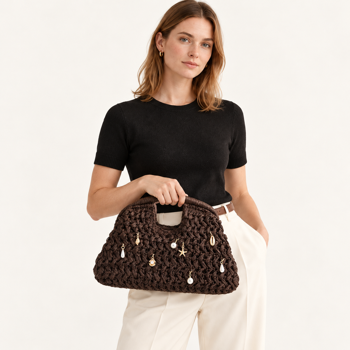 Woman carrying the Beaded Crochet Top Handle Bag in coffee, studio styling