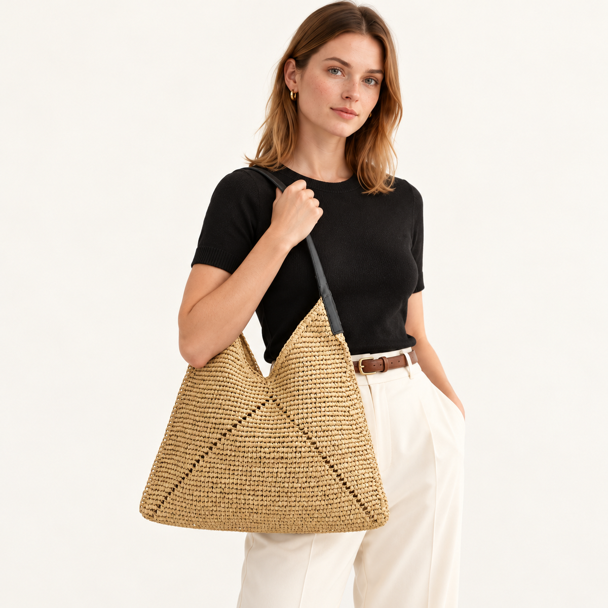 Woman carrying the Triangle Stitch Paper Woven Hobo in light brown / black strap, studio styling