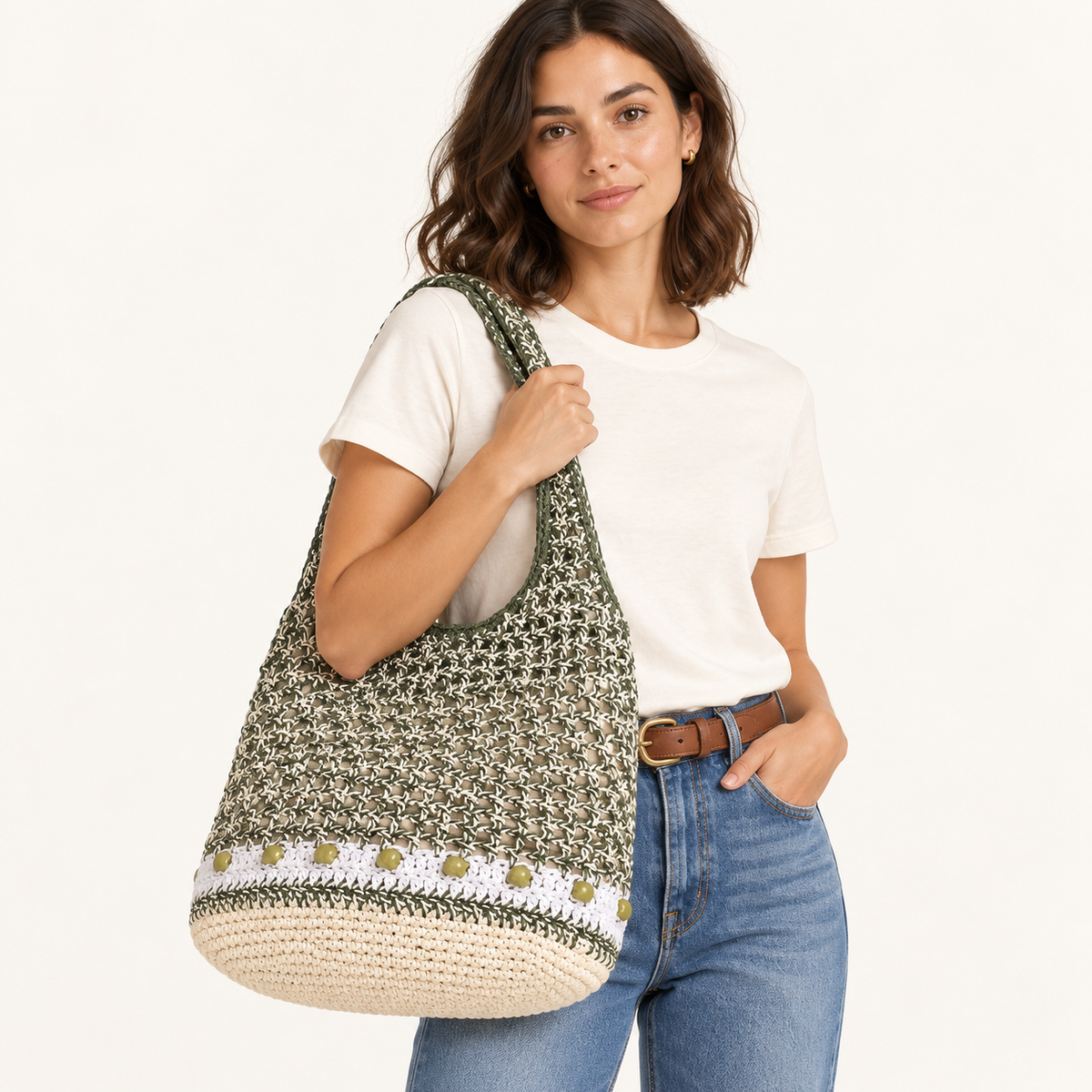 Woman carrying the Beaded Stripe Openwork Tote in green / cream / no charm, studio styling
