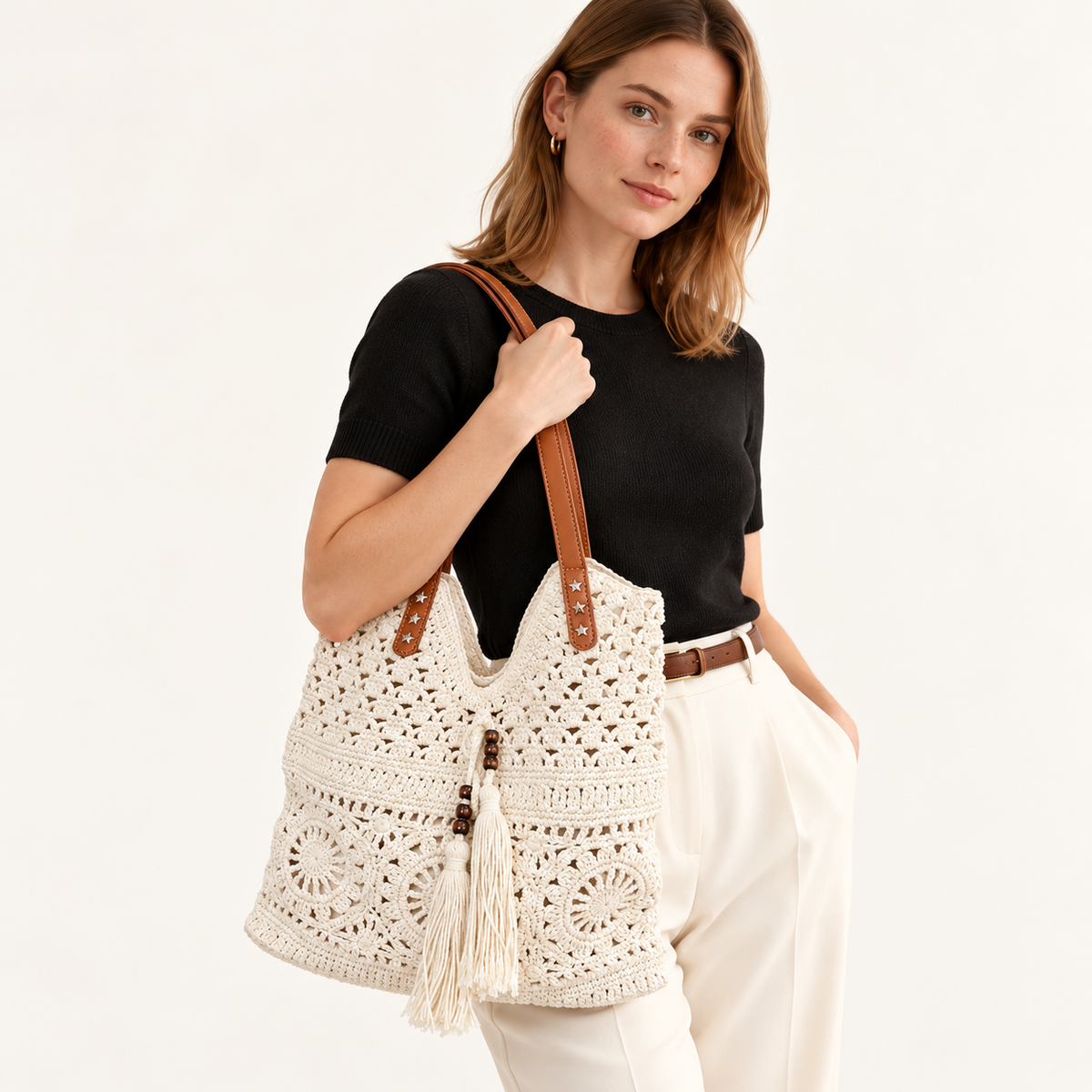 Woman carrying the Medallion Crochet Shoulder Tote in ivory / brown handles, studio styling