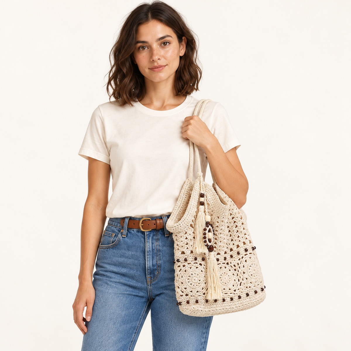 Woman carrying the Ivory Crochet Tassel Hobo in ivory, studio styling