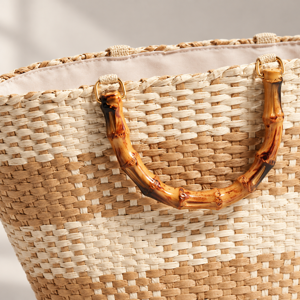 Grid Woven Tote, close-up of cream and tan weave and the bamboo-style handle attachment