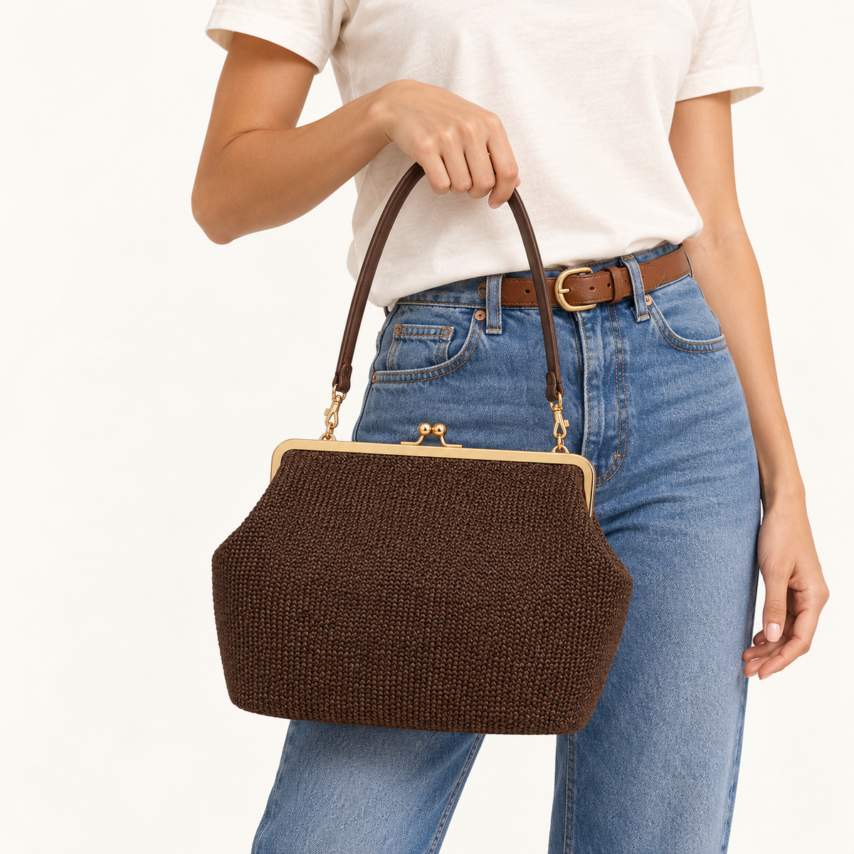Woman carrying the Woven Kiss-Lock Frame Bag in coffee woven