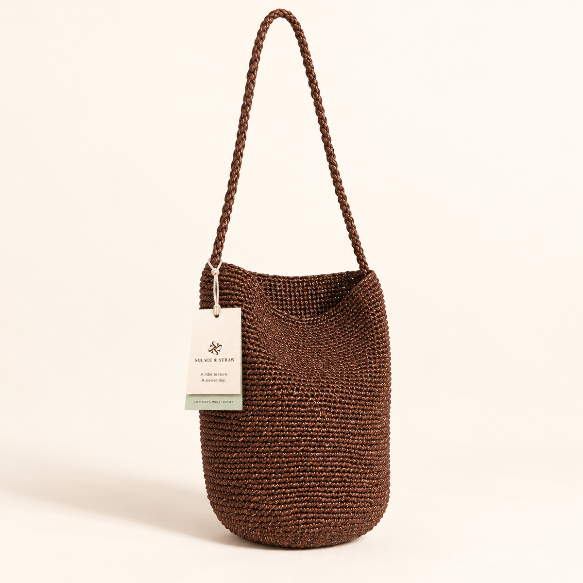 Braided Strap Woven Bucket Bag — Brown, brown, front view with Solace & Straw hangtag