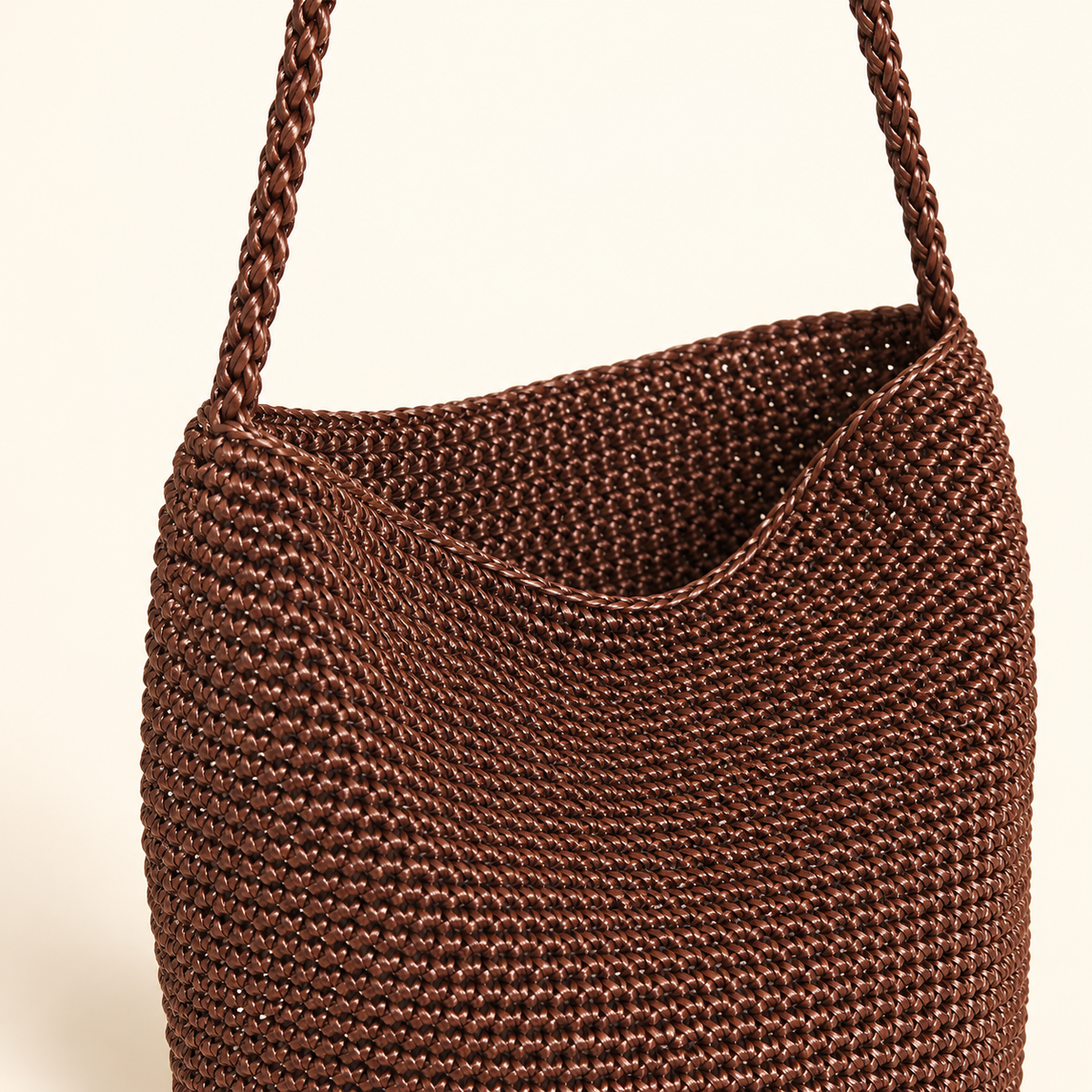 Braided Strap Woven Bucket Bag — Brown, close-up of braided strap attachment and brown weave