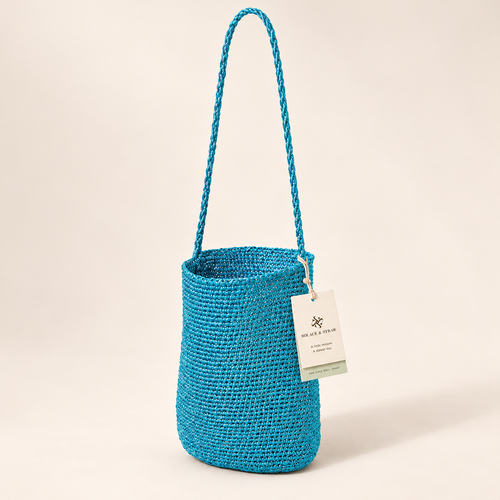 Braided Strap Woven Bucket Bag — Turquoise, turquoise, front view with Solace & Straw hangtag