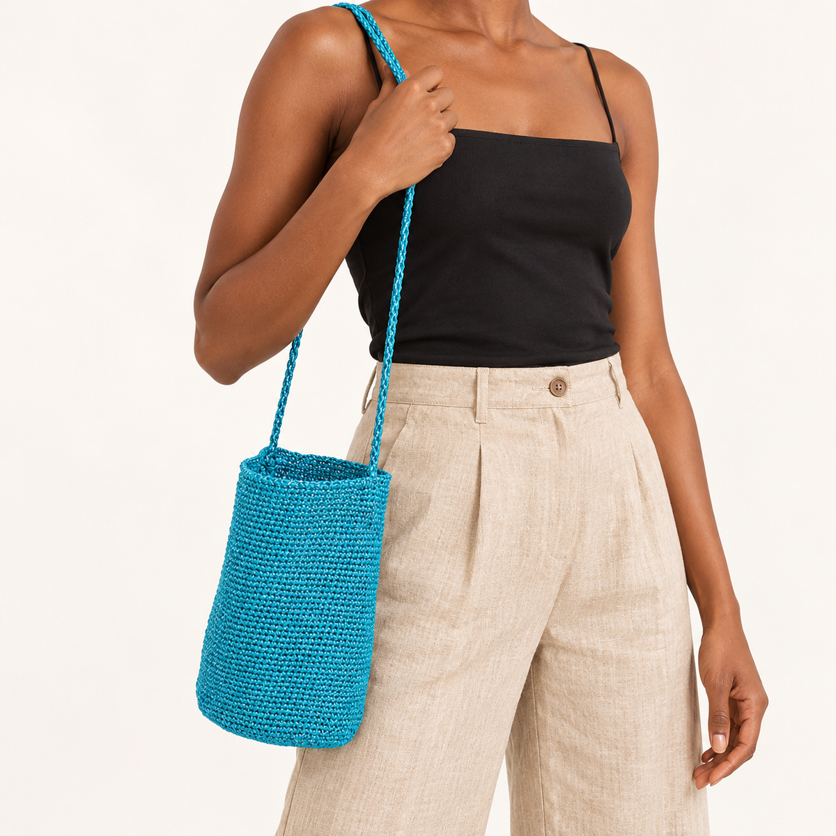 Woman carrying the Braided Strap Woven Bucket Bag — Turquoise in turquoise