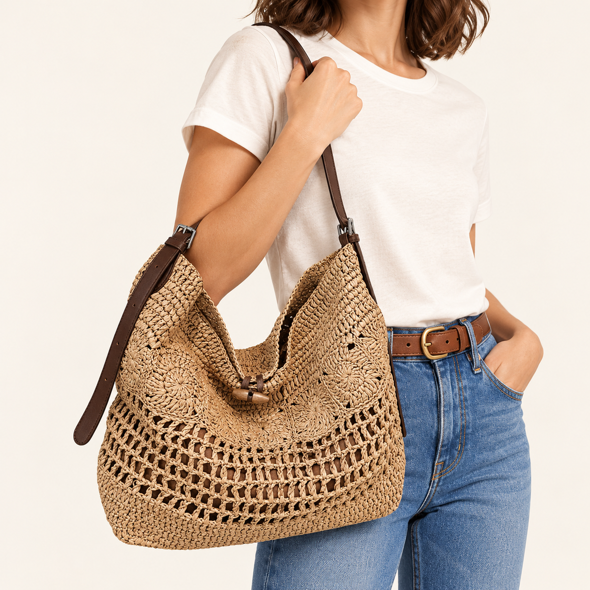 Woman carrying the Openwork Woven Hobo Bag in khaki / brown strap